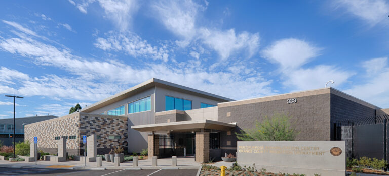 Exterior of the Multipurpose Rehabilitation Center, Orange County Probation Department, with parking lot and blue sky.
