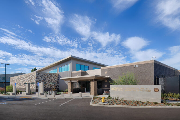 Exterior of the Multipurpose Rehabilitation Center, Orange County Probation Department, with parking lot and blue sky.
