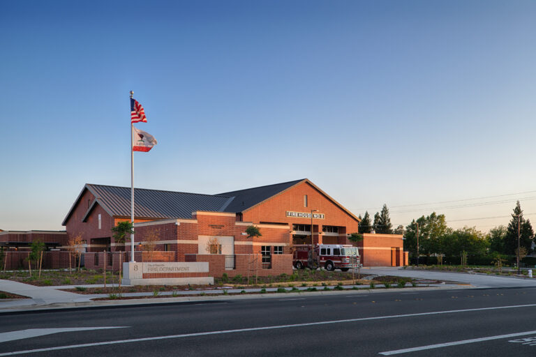 Brick fire station with a fire engine parked outside, marked Fire House No. 8 and City of Roseville Fire Department.