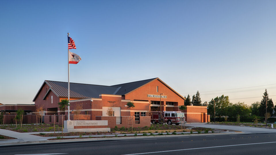 Brick fire station with a fire engine parked outside, marked Fire House No. 8 and City of Roseville Fire Department.