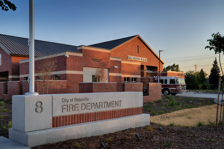 City of Roseville Fire Department Station 8, a brick firehouse with a fire engine parked outside at dusk