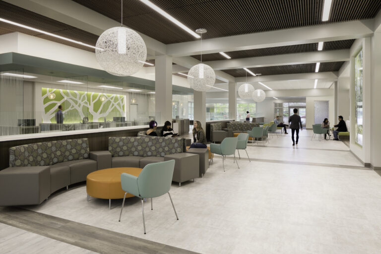 Modern hospital or office waiting area with curved seating, hanging globe lights, and people talking