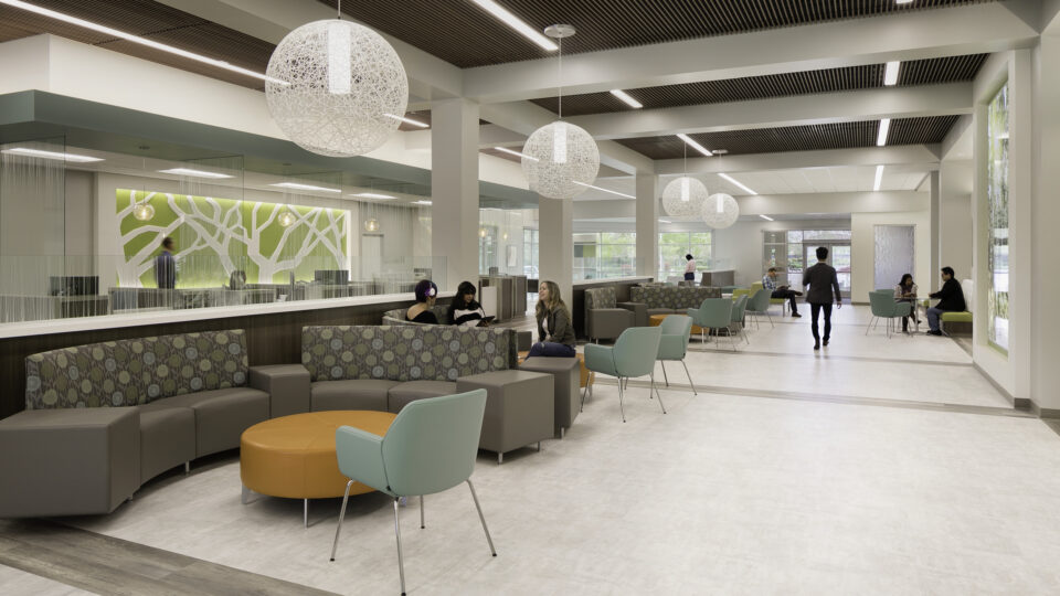 Modern hospital or office waiting area with curved seating, hanging globe lights, and people talking
